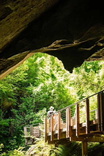 Man with backpack walking by trail in caves