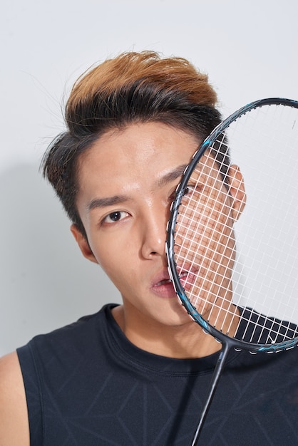 Man with badminton racket, portrait