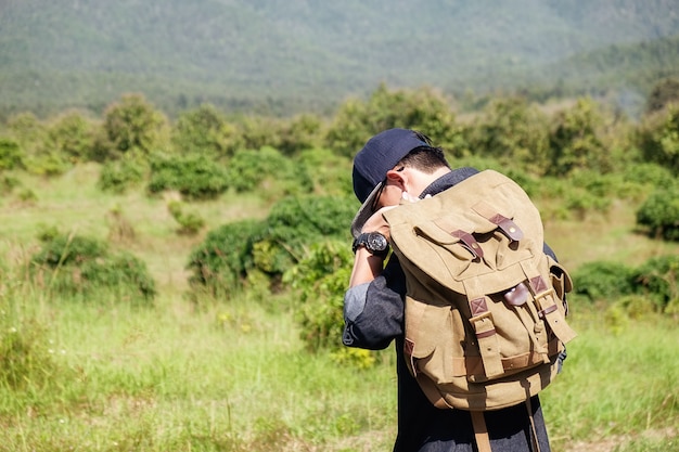 man with a bagpack in the country