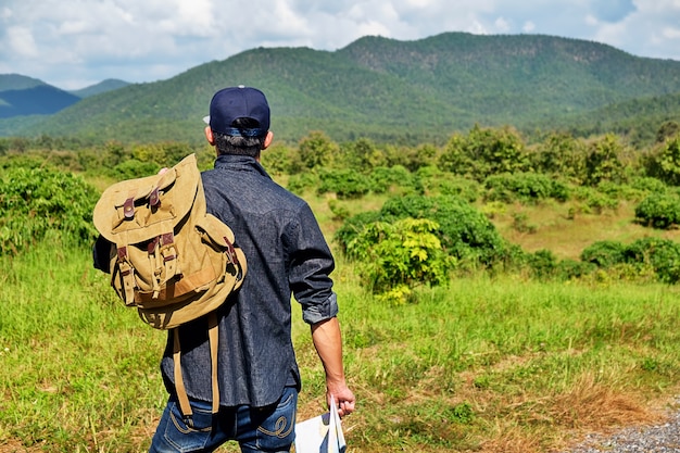 man with a bagpack in the country