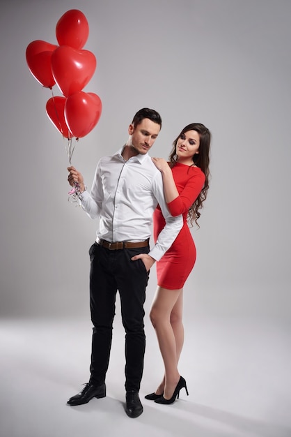 Man with balloons next to his lady