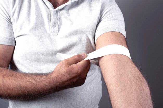 man with bandaged on arm