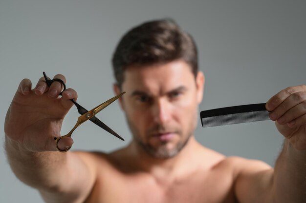 Man with barbers scissors man cut hair with hairdressing scissors men haircut in barbershop barber s