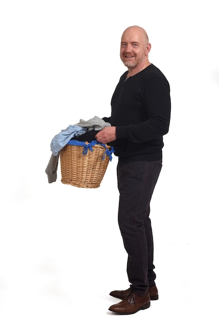 A man with a basket of dirty clothes on white background