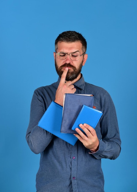 Man with beard and books Notebooks in blue color