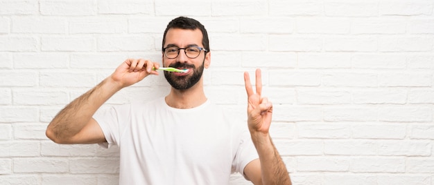 Man with beard brushing teeth