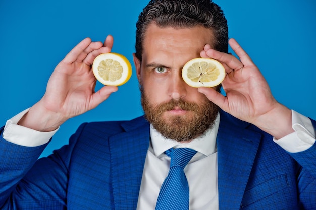 Man with beard or businessman holding yellow fruit, lemon