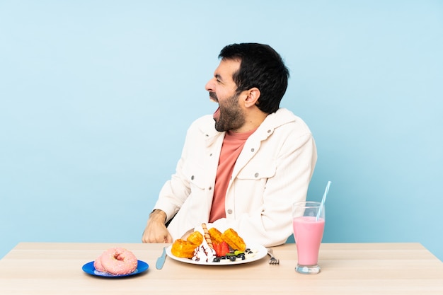 Man with beard drinking a milkshake 