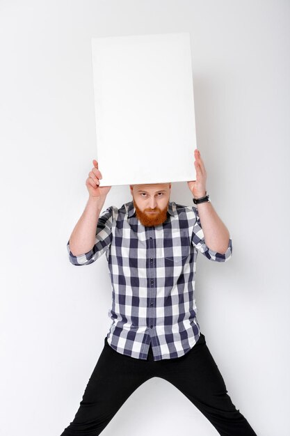 Man with beard holding big white card