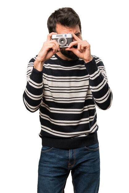 Man with beard holding a camera