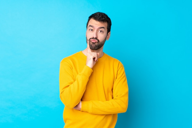 Man with beard over isolated blue wall