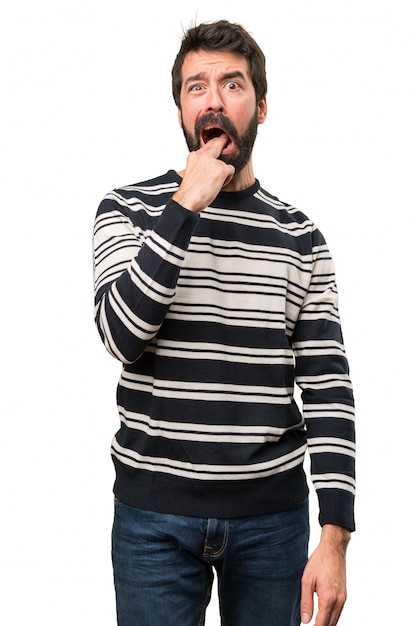 Man with beard making vomiting gesture