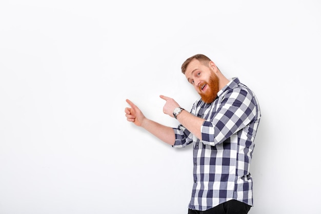 Man with beard pointing copy space