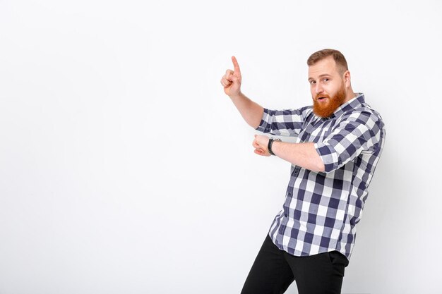 Man with beard pointing copy space