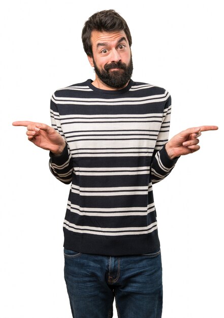 Man with beard pointing to the laterals having doubts