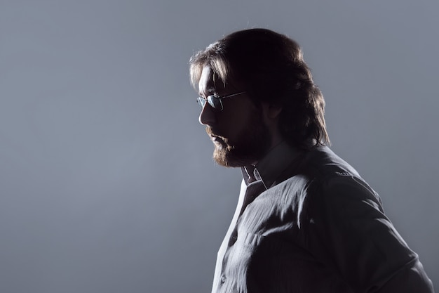 Man with beard, profile on grey background, the silhouette.