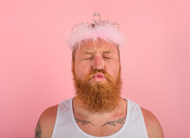 Man with beard , tattoos and crown acts like a princess