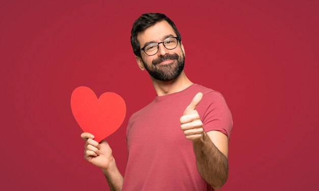 Man with beard in valentine day over red background