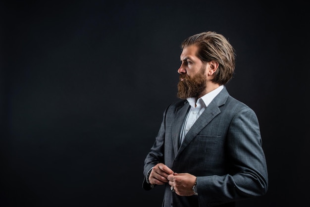 Man with beard wear grey suit corporate style, public speaker concept.
