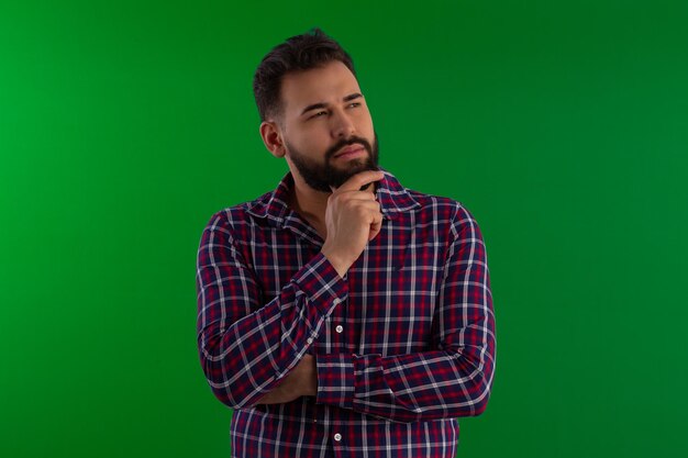 Photo man with a beard wearing a plaid shirt in a studio photo with a green background ideal for cropping