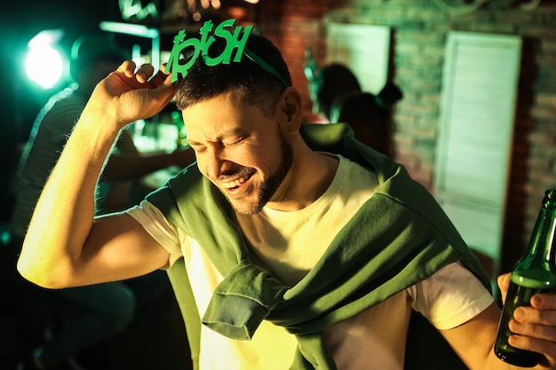 Man with beer celebrating St Patrick39s day in pub