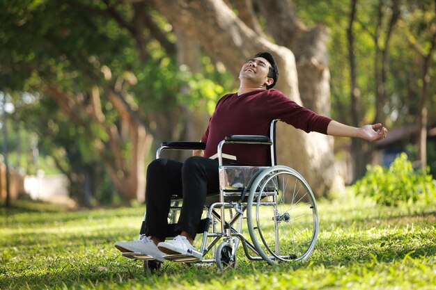 Man with bicycle sitting on grass