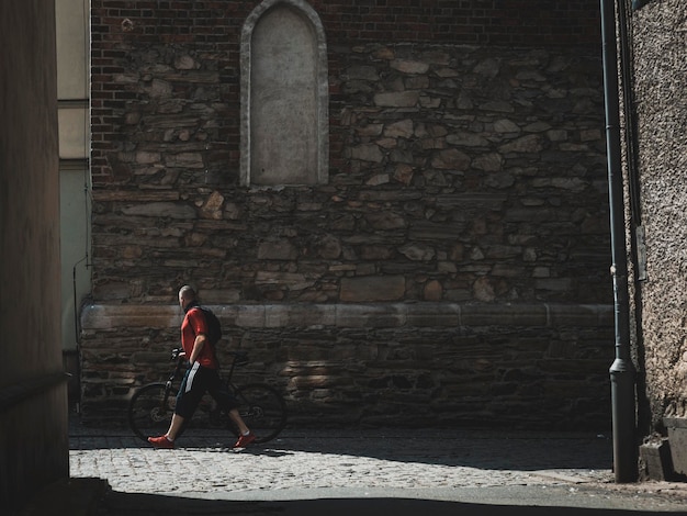 Man with bicycle on the street of old town