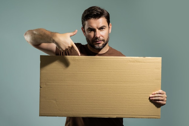 Man with blank banner isolated on studio background portrait of attractive man with empty blank post