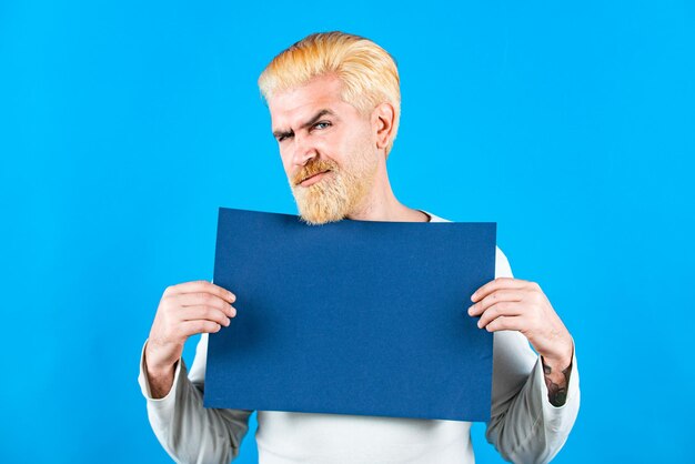 Man with blank sheet paper advertising banner season sales man holding empty placard board for media...