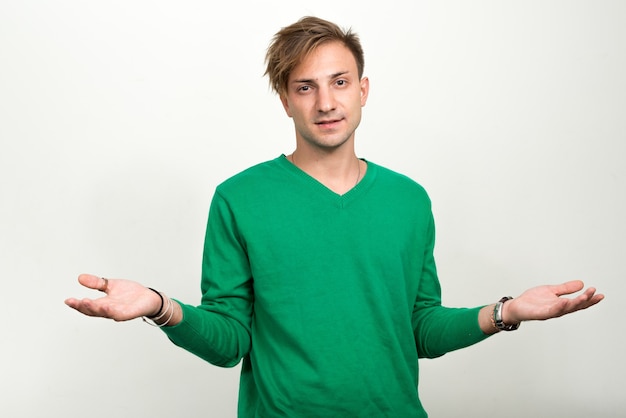  man with blond hair against white wall