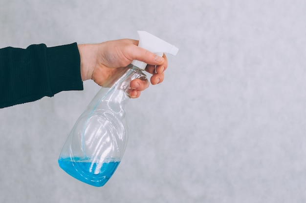 Man with a blue antiseptic in his hand