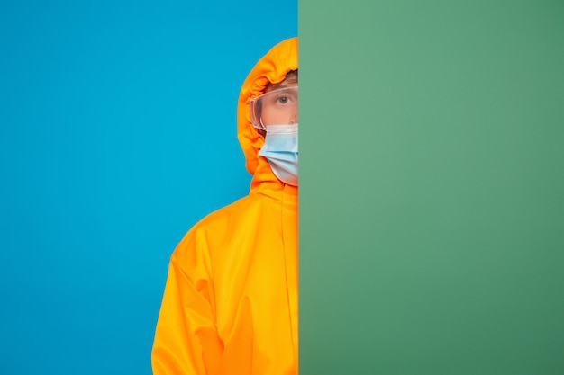 Man with blue and green paper banner with blank space