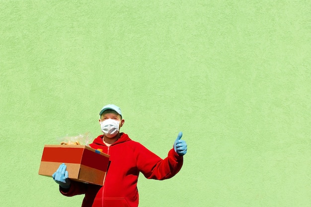 Photo the man with a box of food, help and donation of food