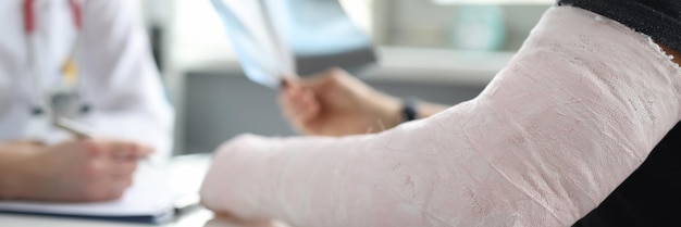 Man with broken arm at doctor appointment