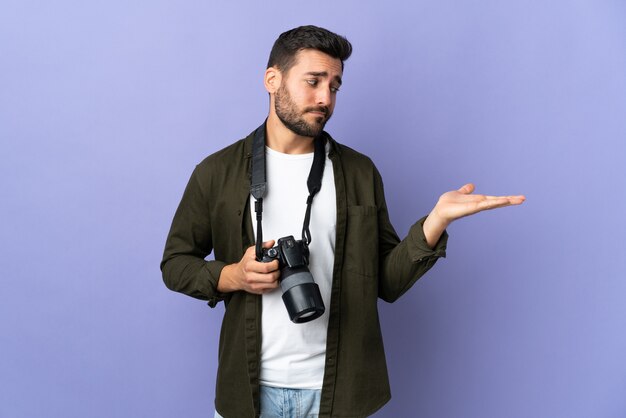 Photo man with a camera in studio