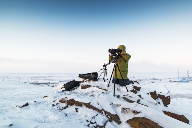 Man with a camera on a tripod