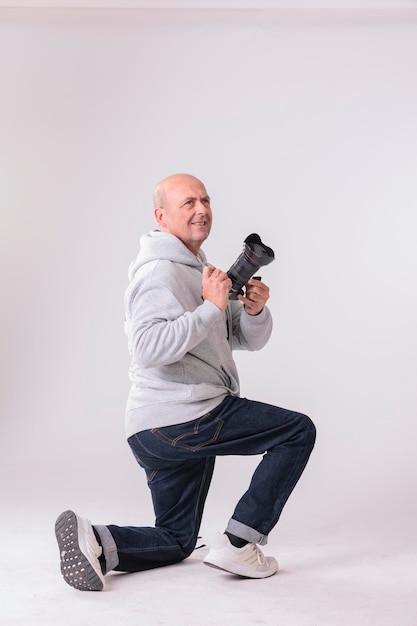 Man with camera on white background