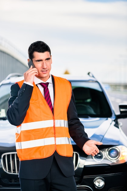 Man with car breakdown calling towing company