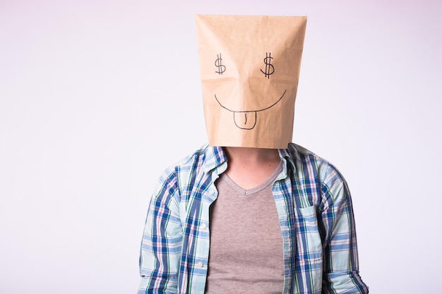 Man with cardboard box on his head with picture of dollar symbol instead of eyes.