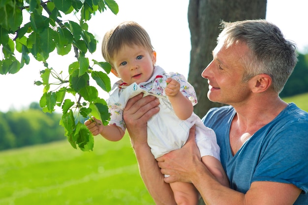 Man with the child babe learns the world