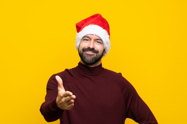 Man with christmas hat shaking hands for closing a good deal