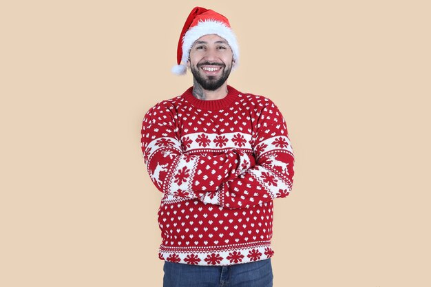 man with christmas santa hat, smiling beige background