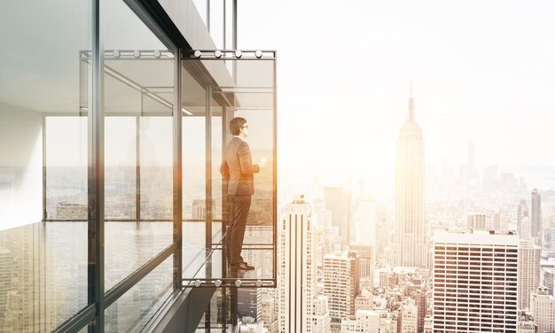 Man with coffee on balcony