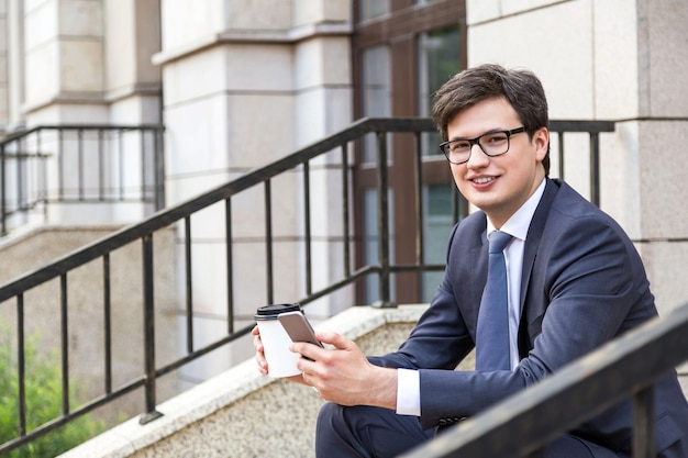 Man with coffee and phone