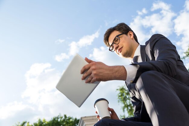 Man with coffee and tablet