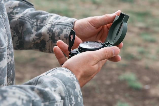 Man with compass in hand outdoor