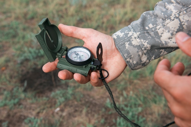 Man with compass in hand outdoor