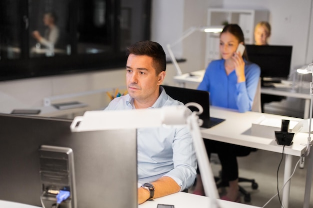 man with computer working at night office