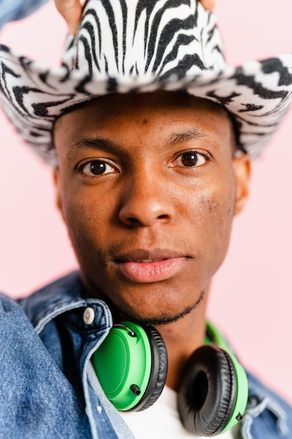 Man with cowboy hat and headphones looking at the camera