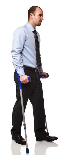 Man with crutch isolated on white